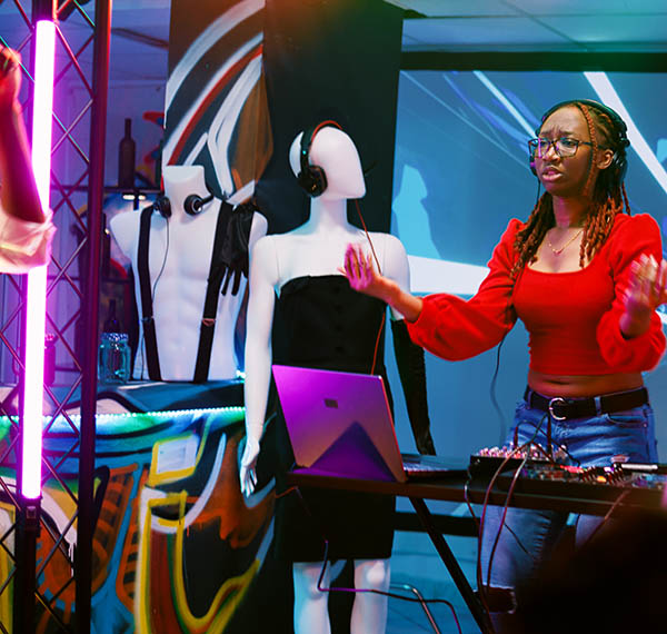 Funky DJ using mixing station on stage